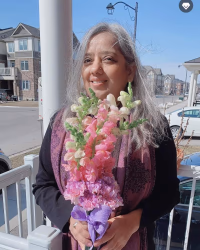 Simply Elegant Florals owner preparing a floral arrangement in the studio