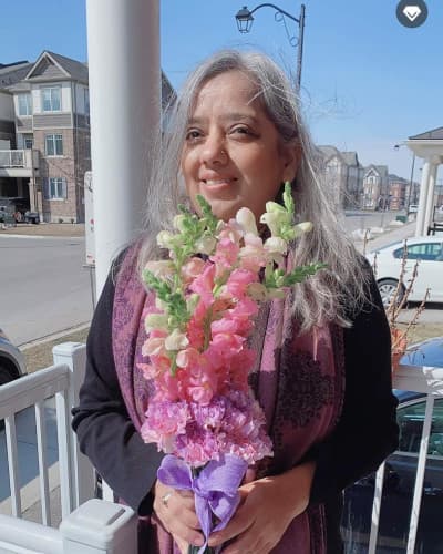 Simply Elegant Florals owner preparing a floral arrangement in the studio
