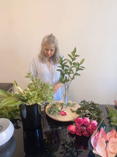 Florist carefully arranging blooms in the Simply Elegant Florals studio