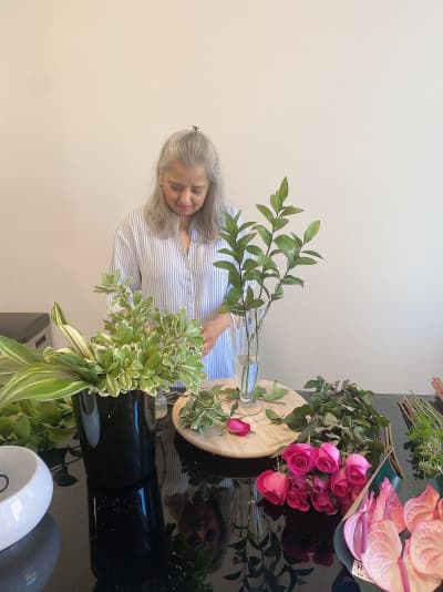 Florist carefully arranging blooms in the Simply Elegant Florals studio