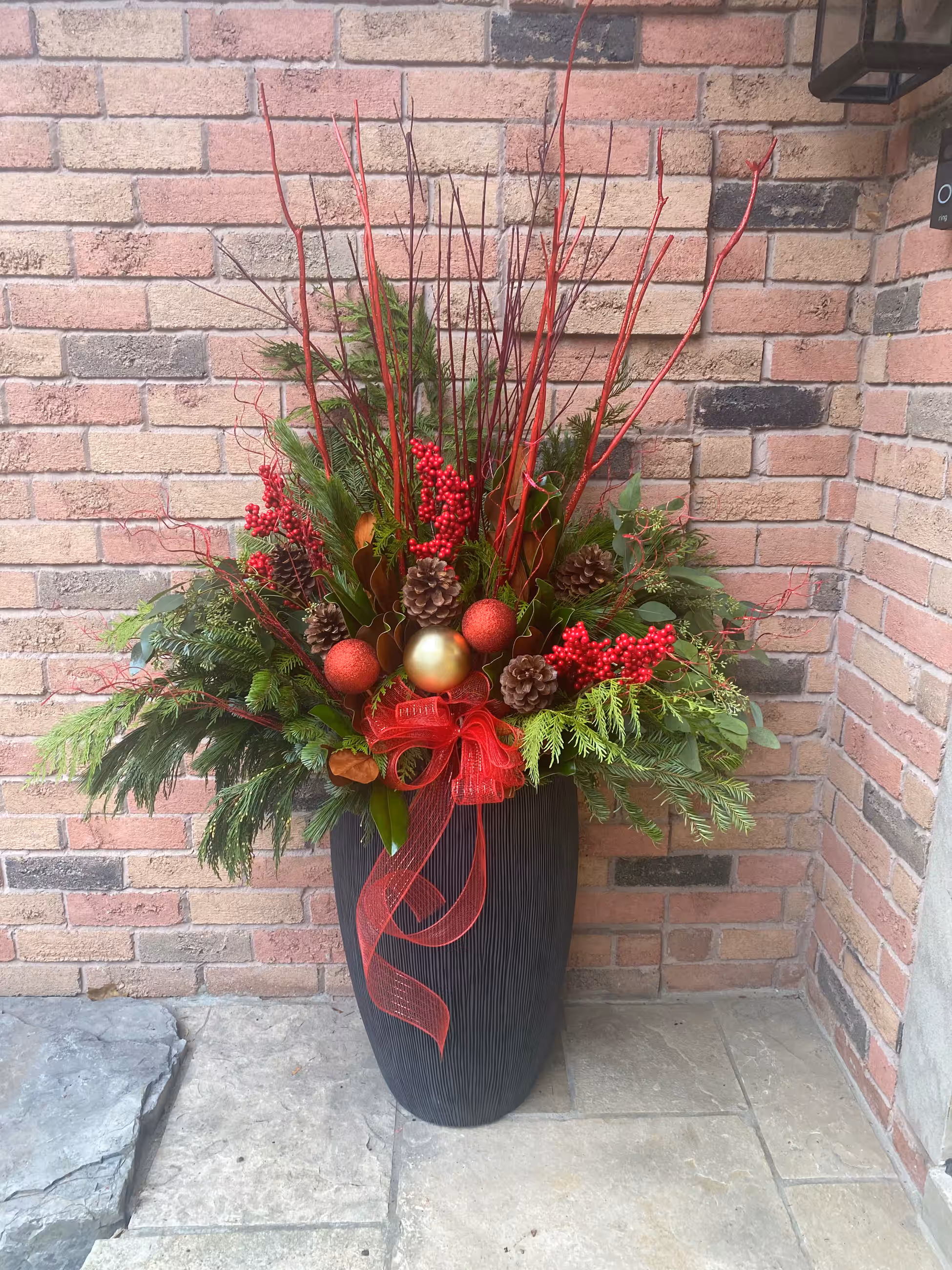 Red berry ornament christmas urn brick corner