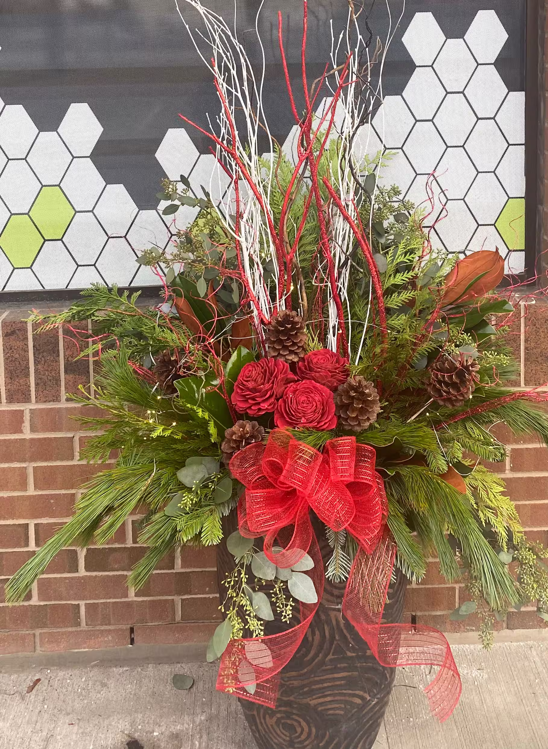 Red rose berry christmas urn bow brick storefront