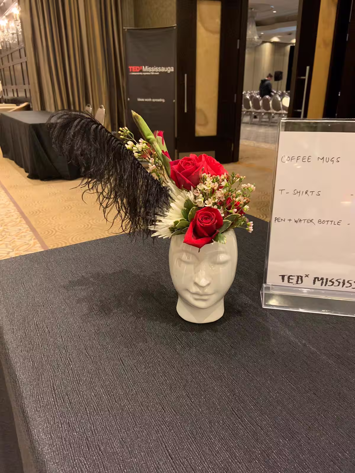 Red rose black feather face vase arrangement