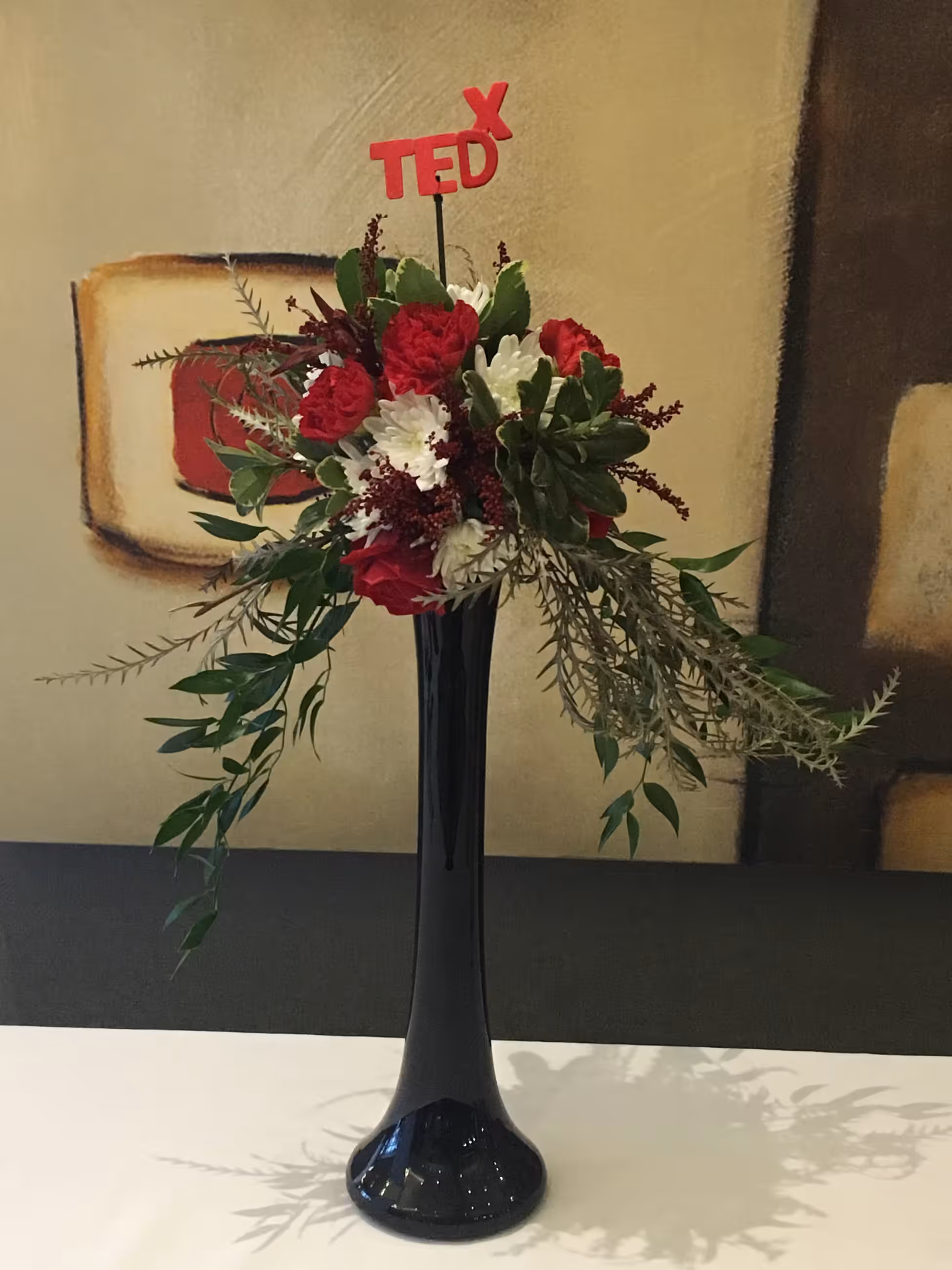 Red white floral black glass vase arrangement