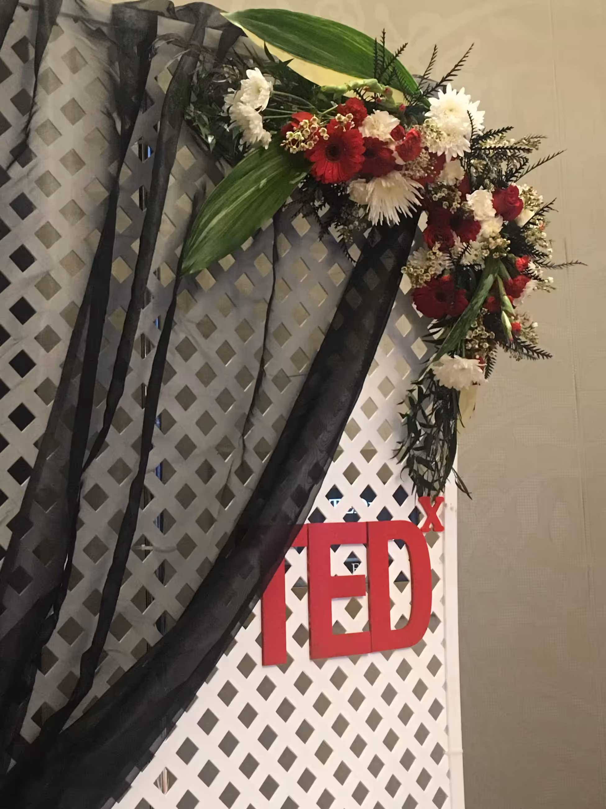 Red white floral lattice backdrop arrangement