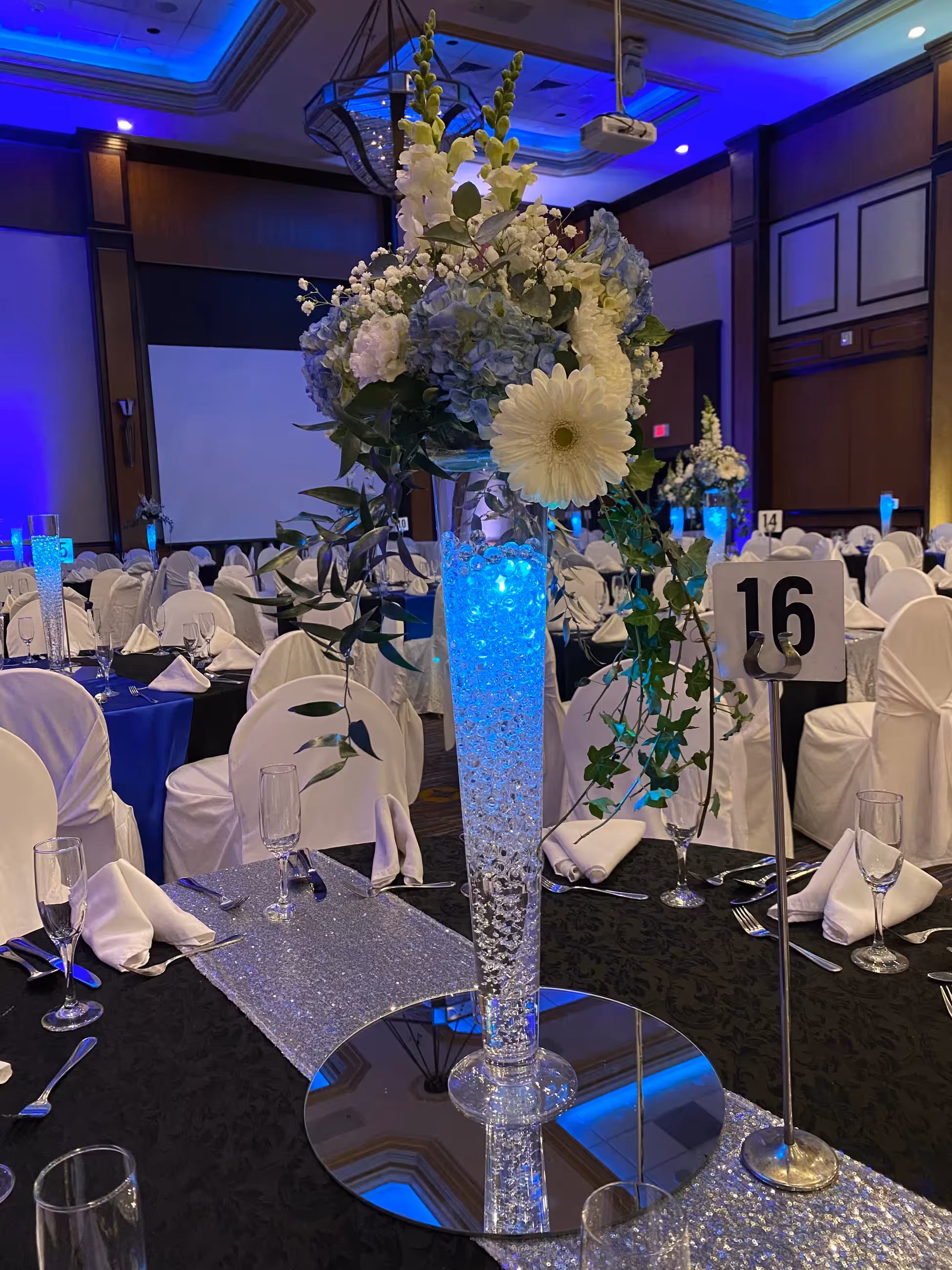 Tall blue white floral centerpiece ballroom closeup