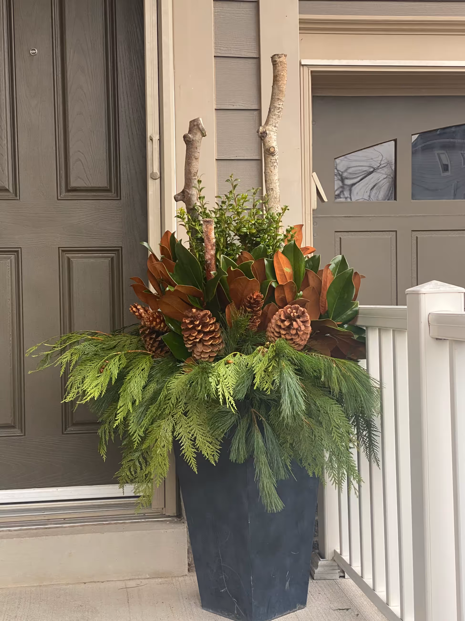 Winter urn magnolia pinecone cedar doorway