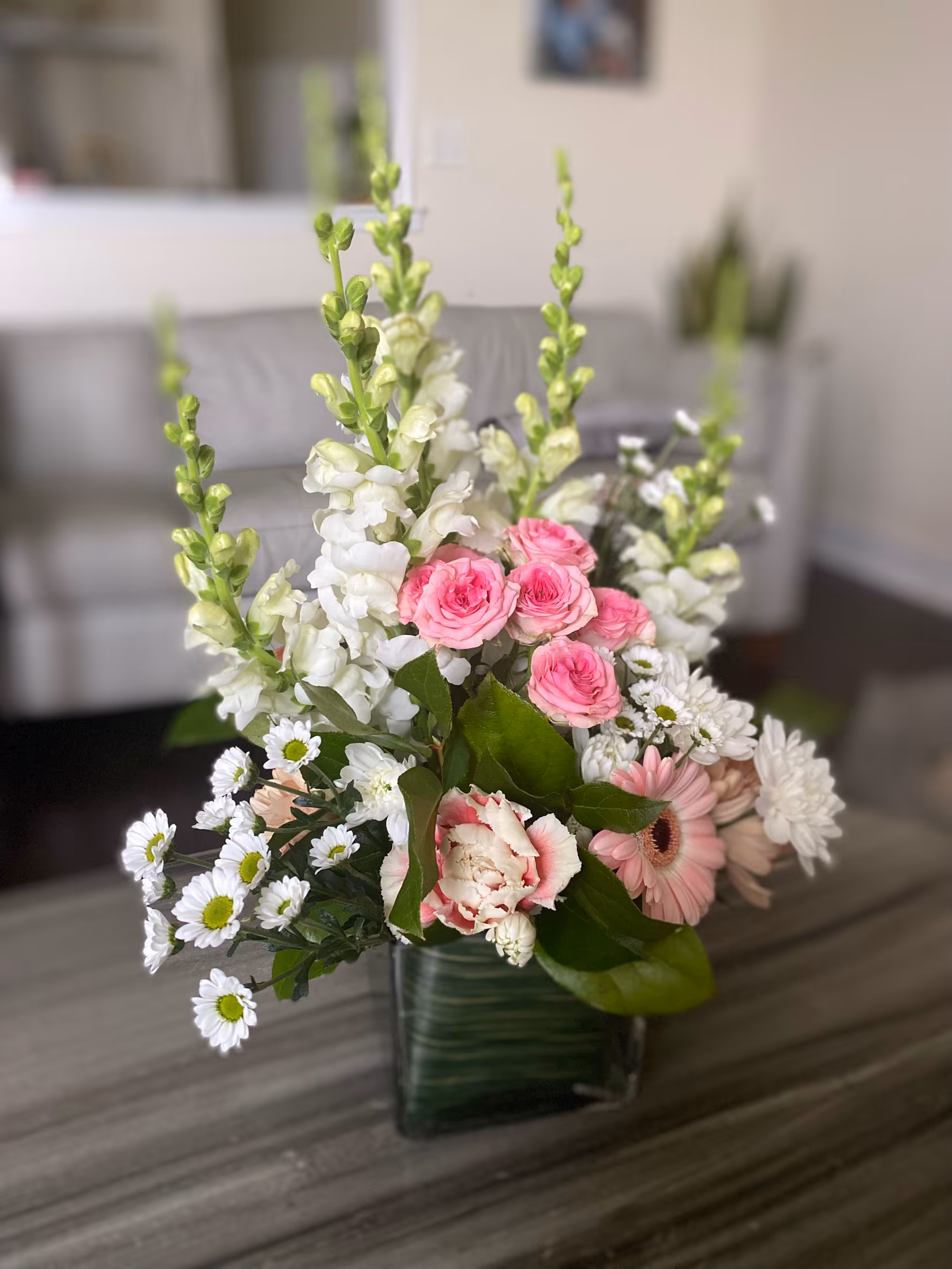 Floral Fantasy arrangement with white snapdragons, pink blooms, and fresh greenery
