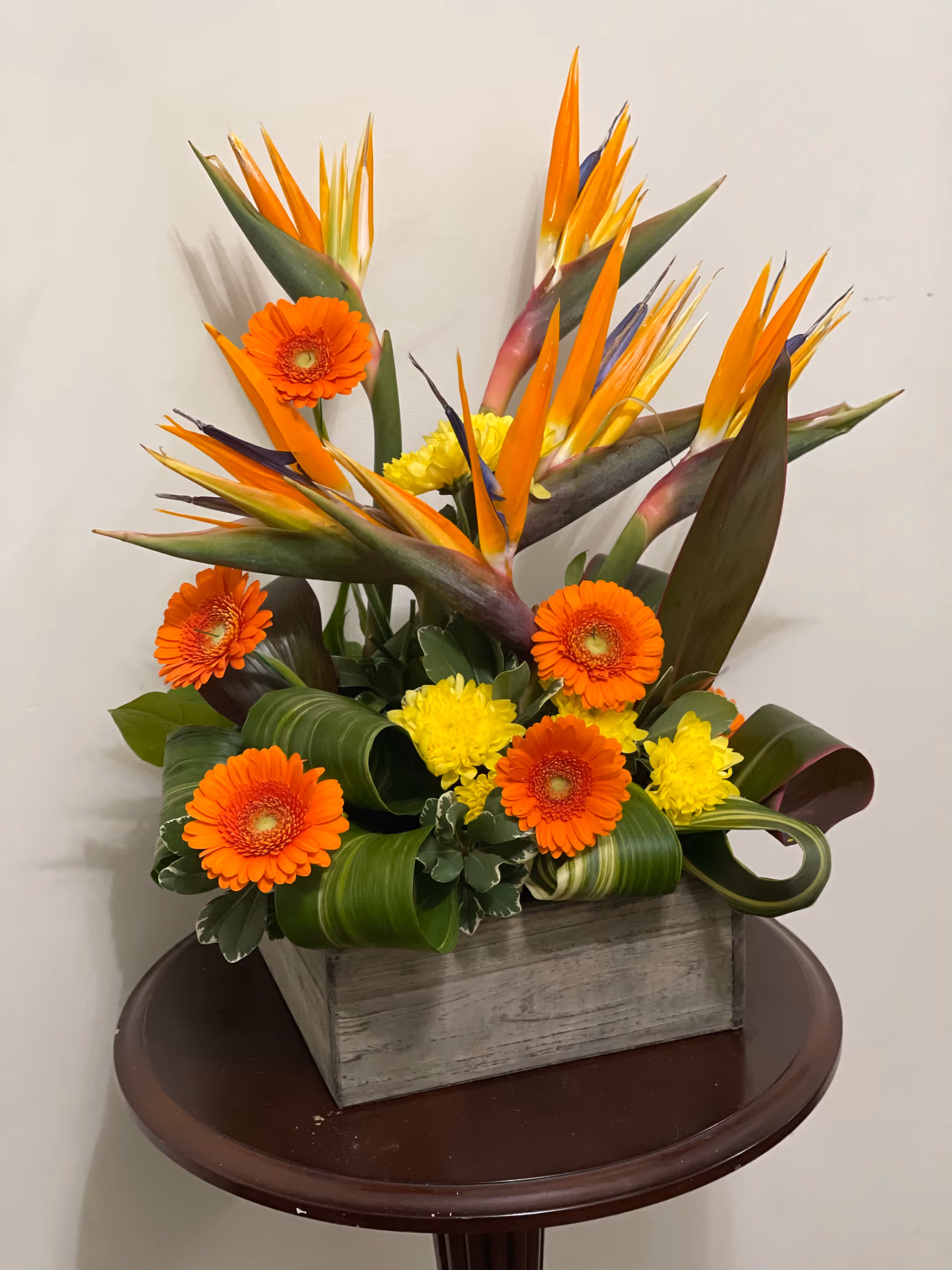Golden Times arrangement featuring Birds of Paradise and colourful seasonal flowers
