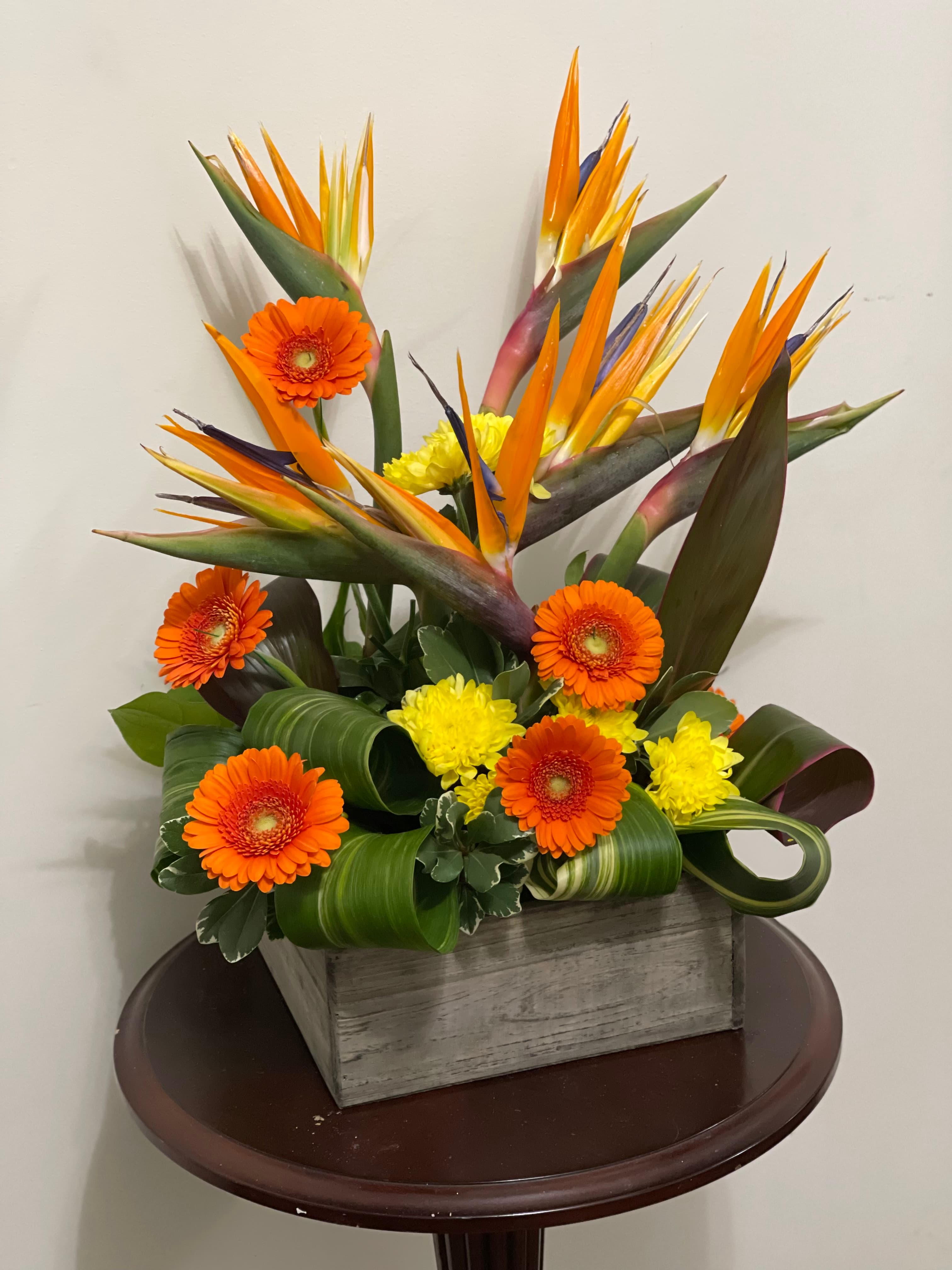 Golden Times arrangement featuring Birds of Paradise and colourful seasonal flowers