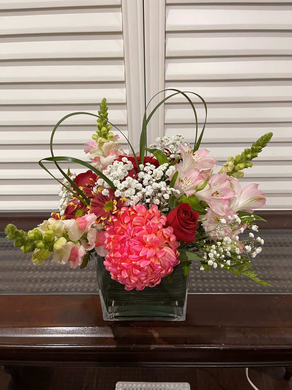 Happiness arrangement with pink seasonal blooms and fresh greenery