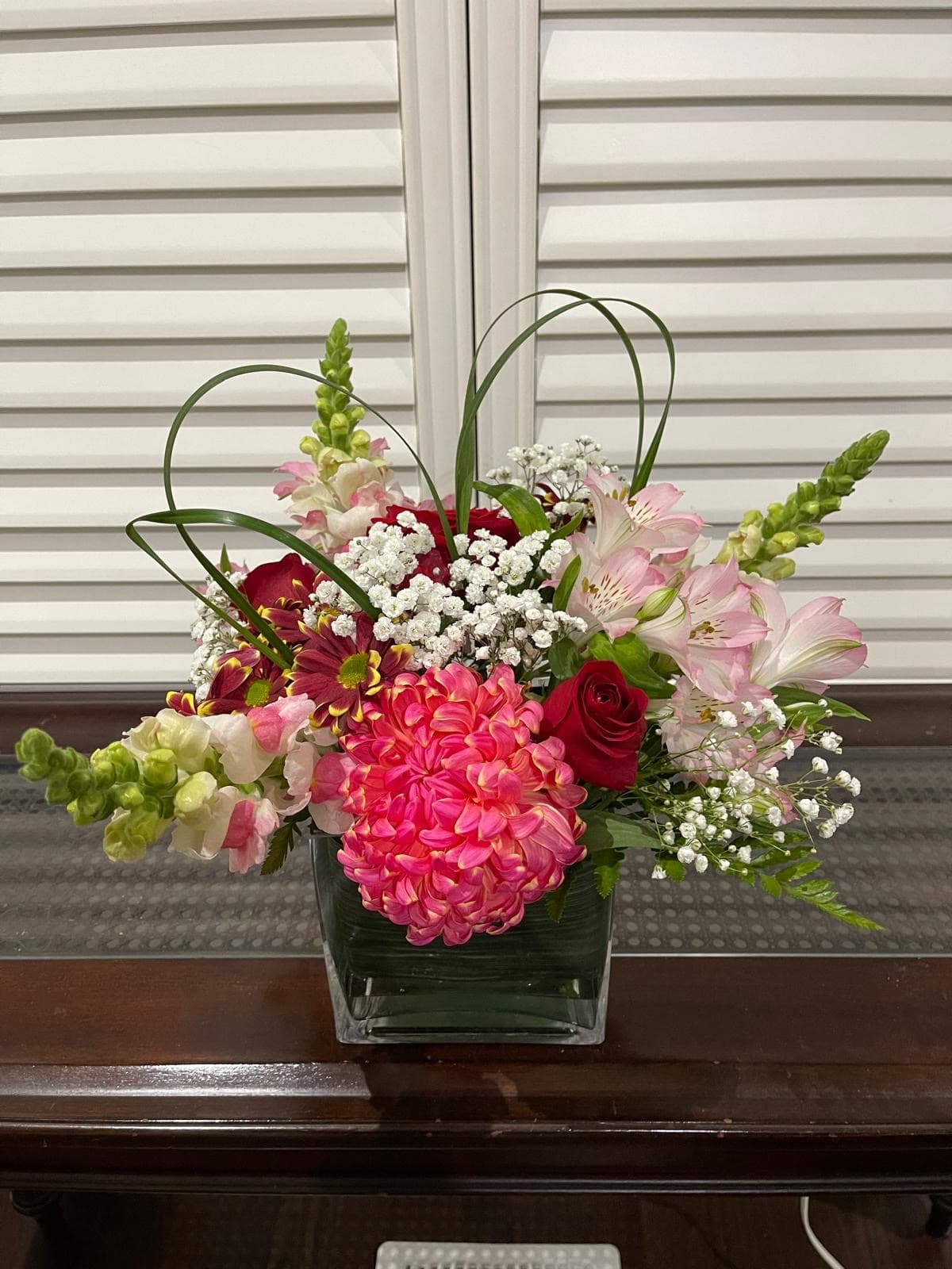 Happiness arrangement with pink seasonal blooms and fresh greenery