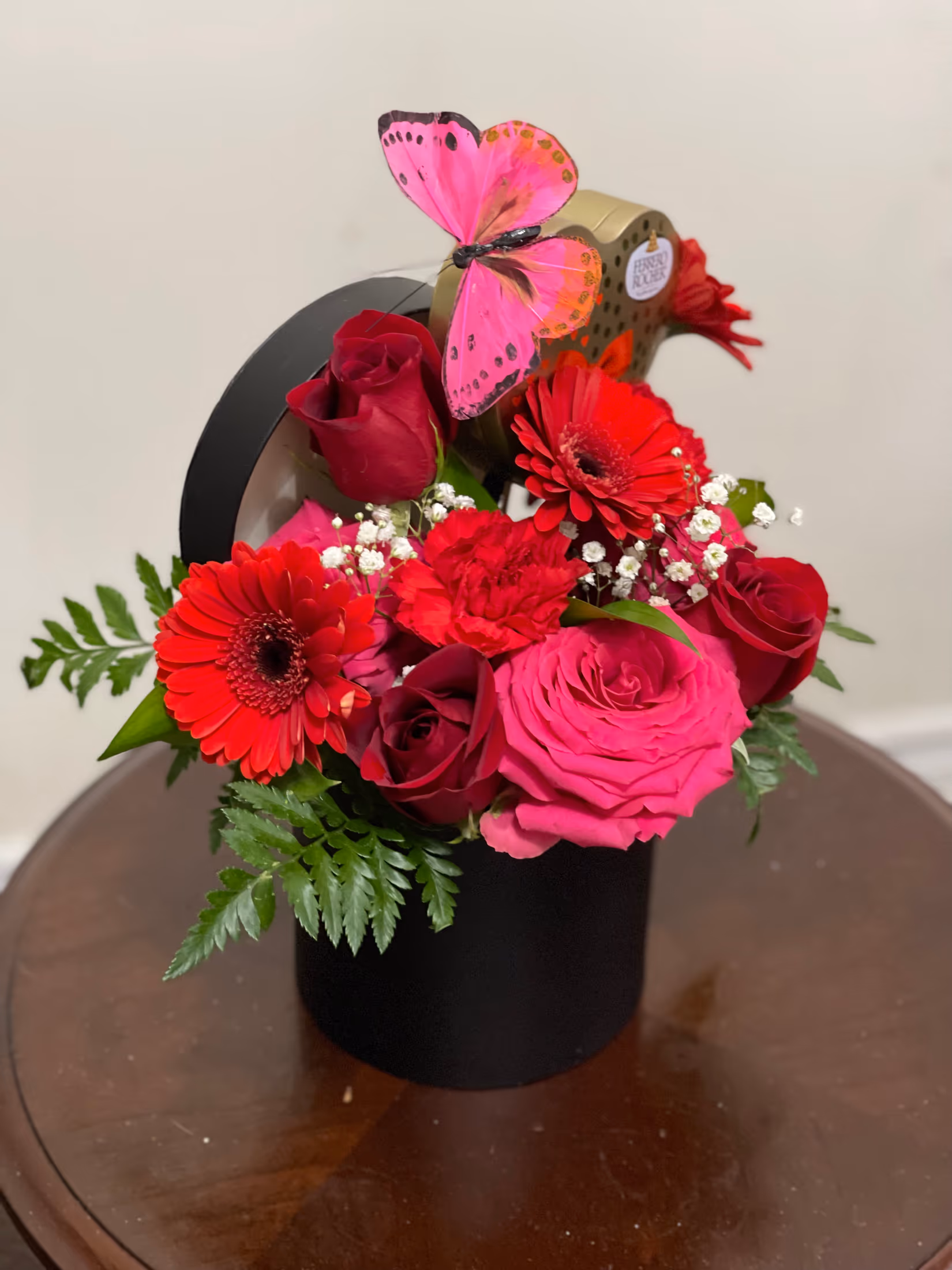 Magic Box floral gift featuring roses, gerbera daisies, chocolates, and a butterfly