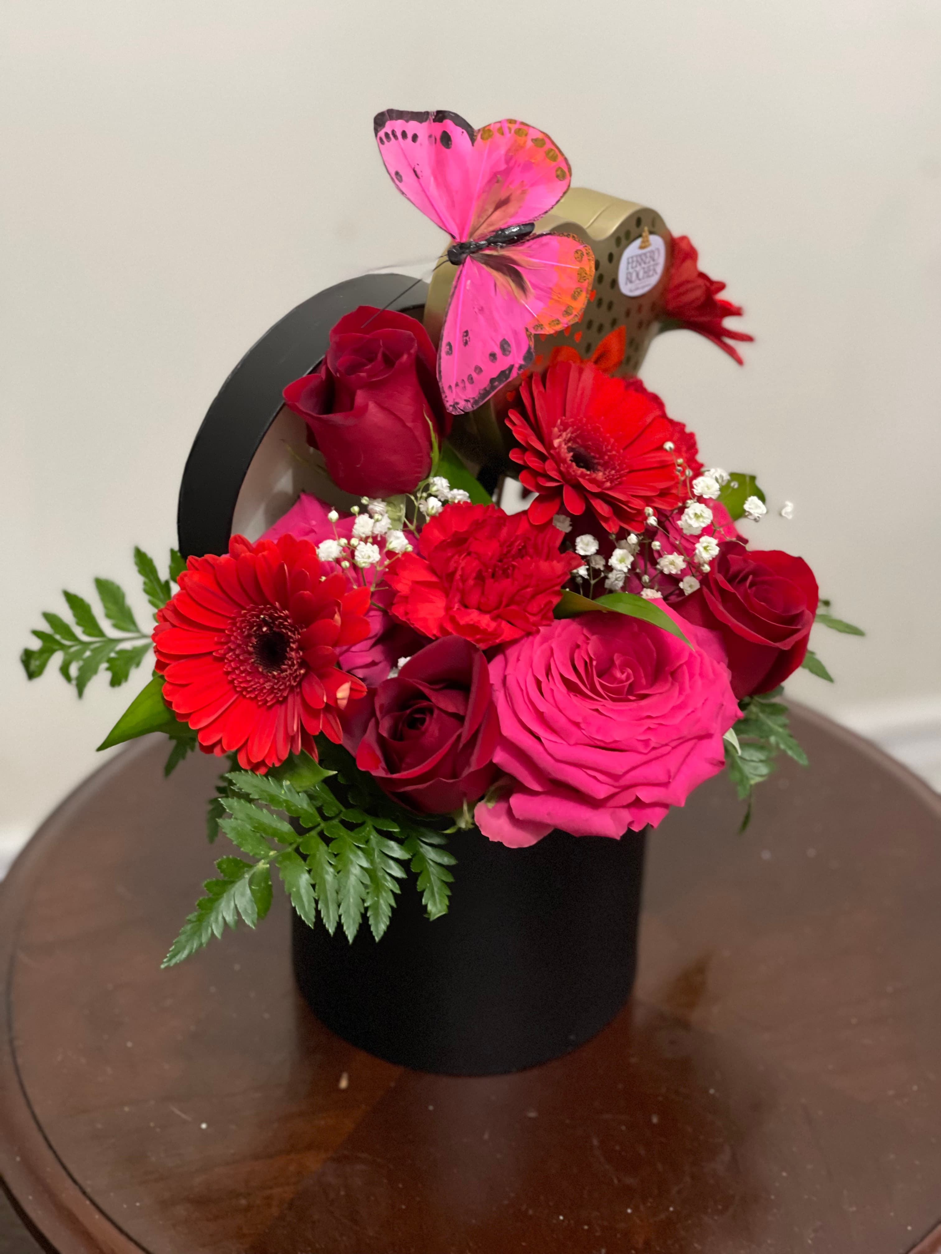 Magic Box floral gift featuring roses, gerbera daisies, chocolates, and a butterfly