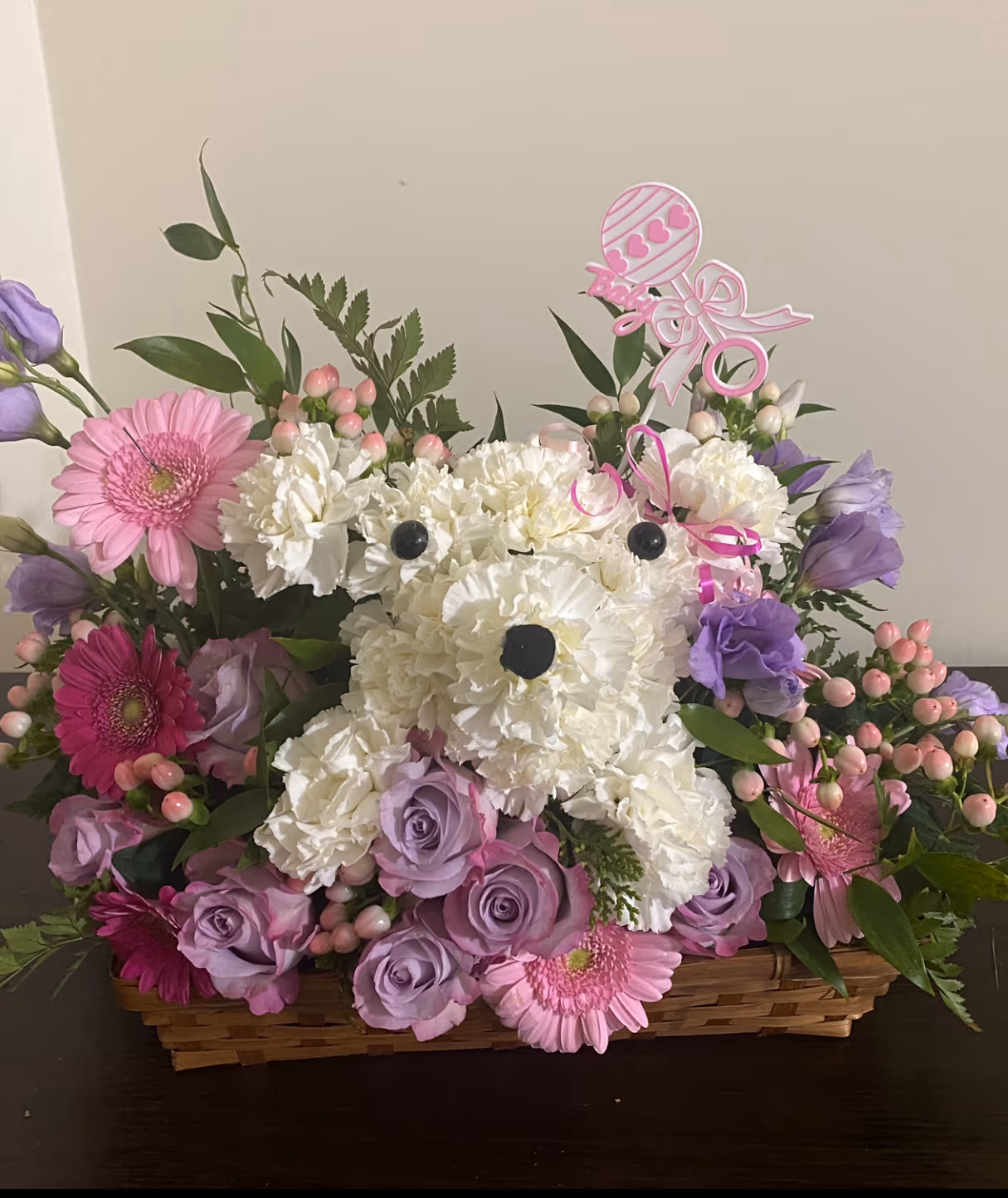 Pretty Paws floral puppy arrangement handcrafted in a decorative basket