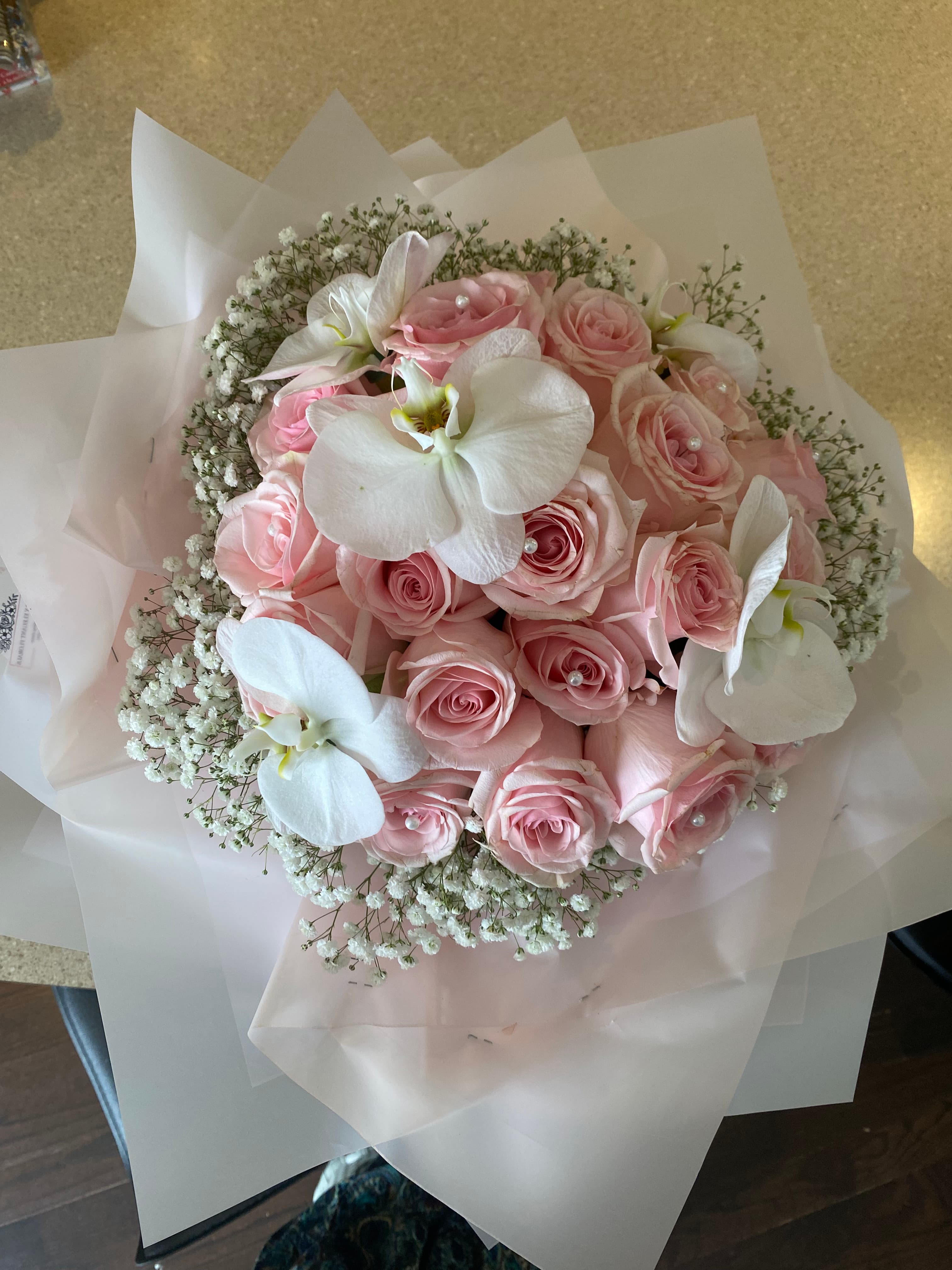 Proposal arrangement with two dozen pink roses, white orchids, and baby's breath