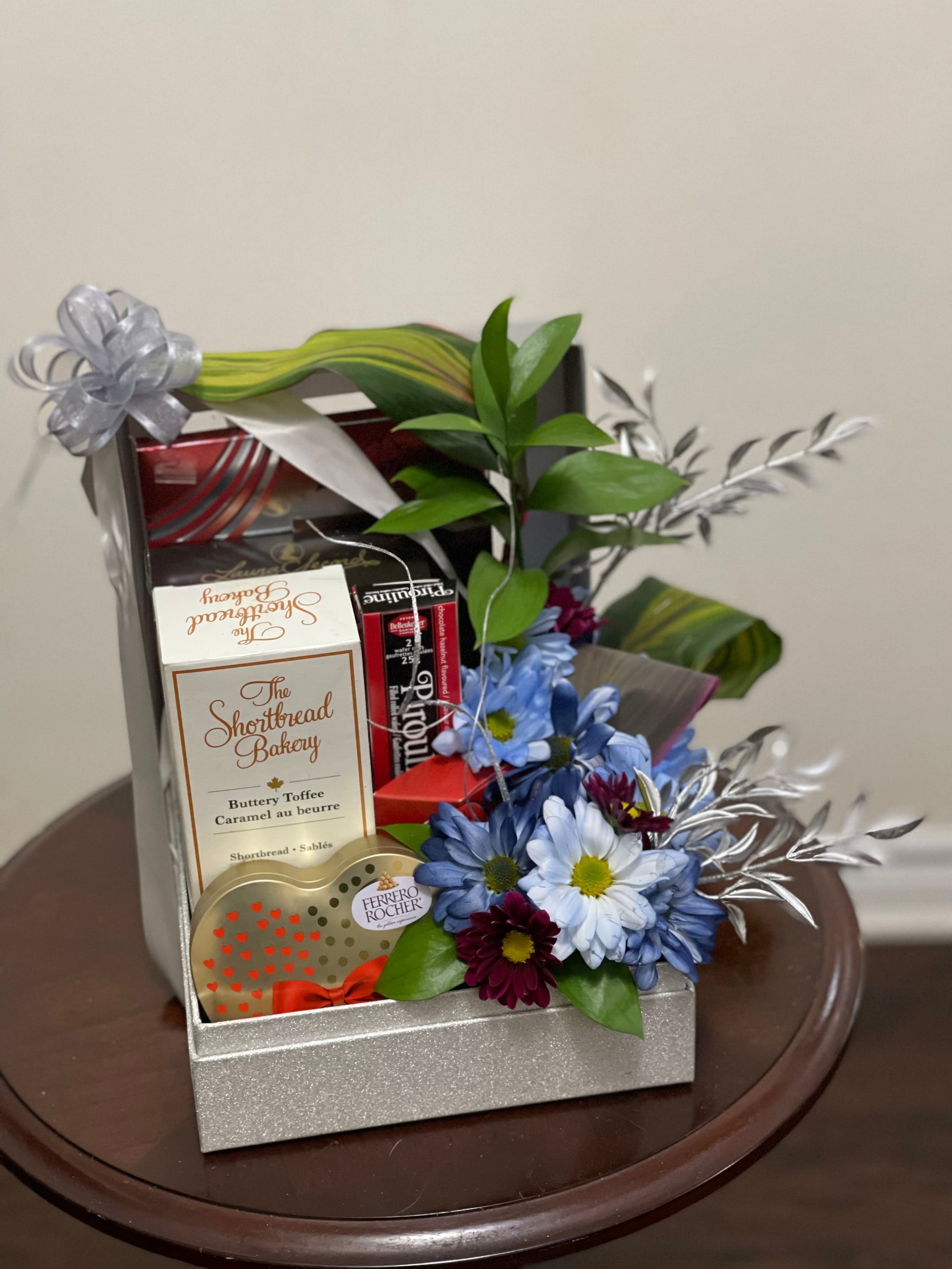 Silver gift box with shortbread, toffee, chocolates, blue daisies, and silver foliage accents