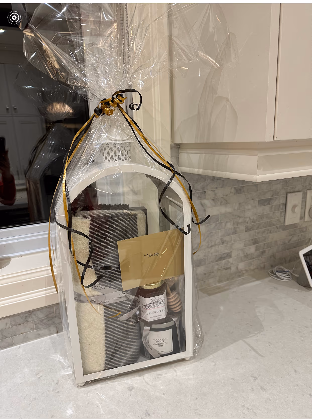 Wrapped lantern-style gift box with a throw, candle, and honey, as pictured in the original store