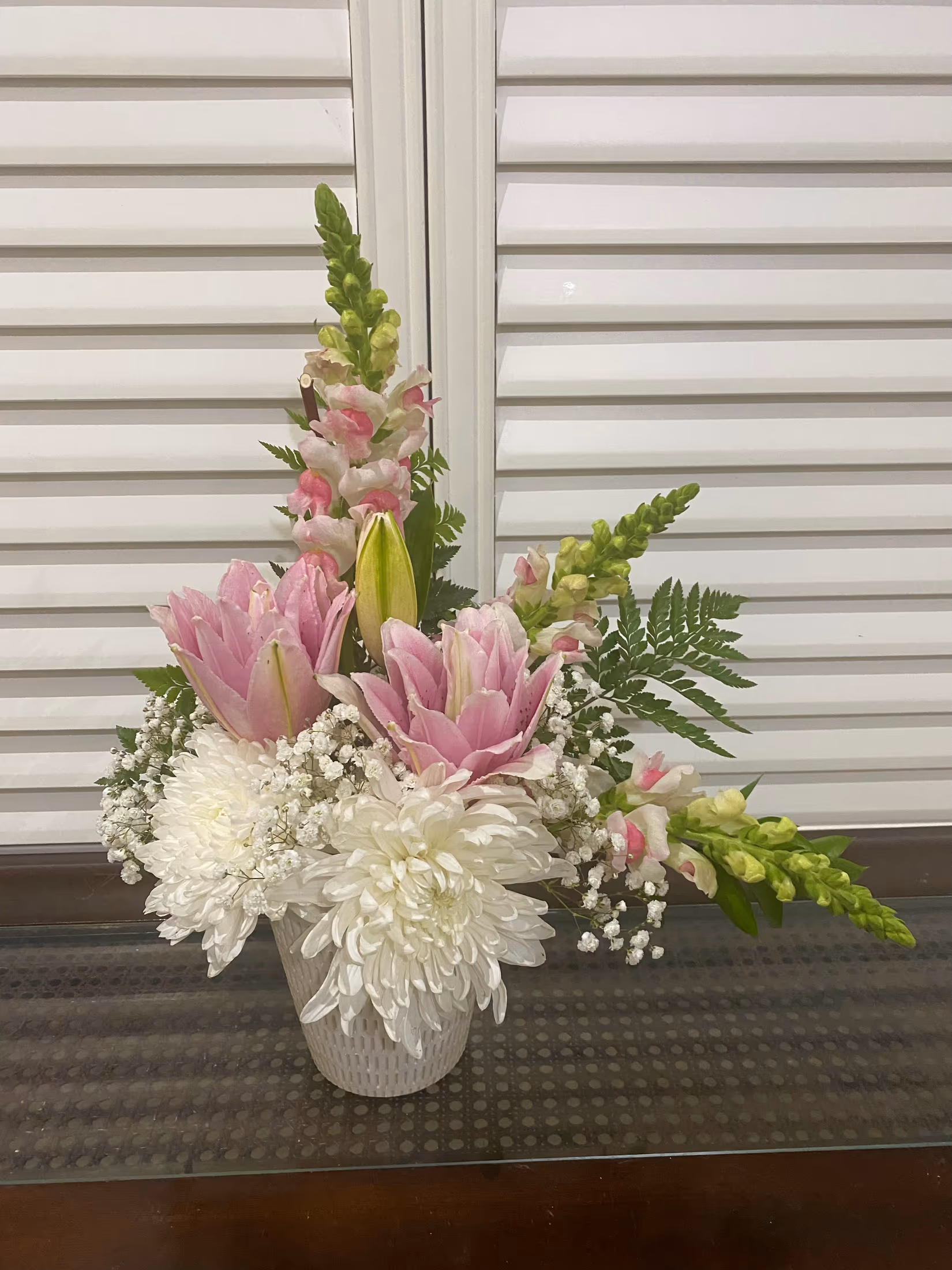 Simply Elegant arrangement with pink snapdragons, lily roses, white chrysanthemums, and greenery