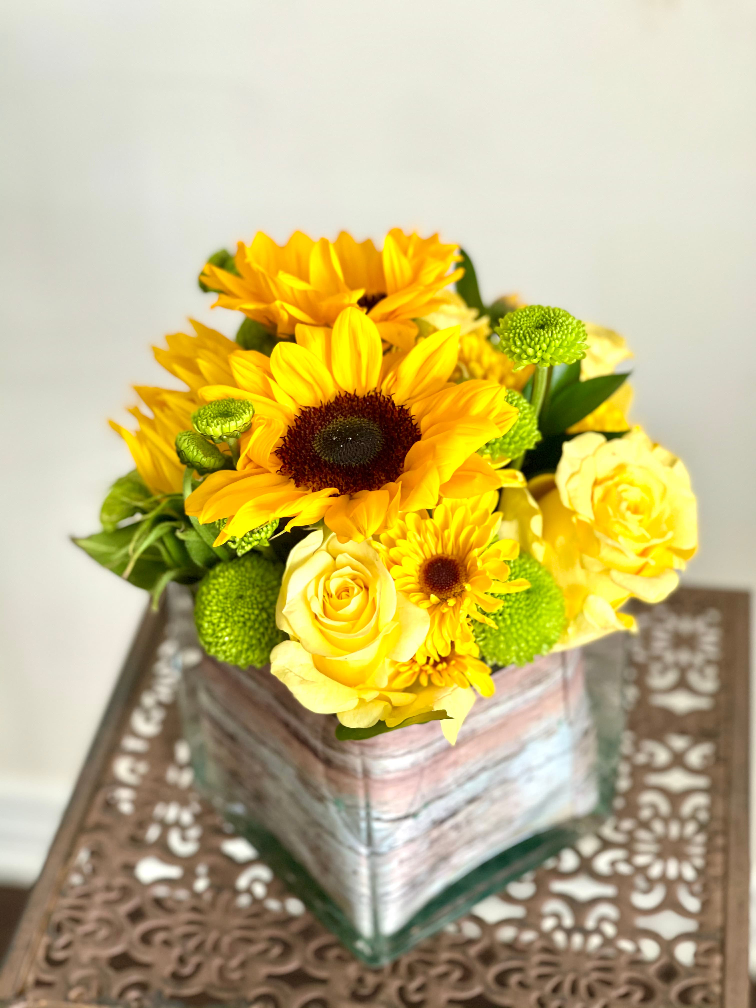 Sunny Flowers arrangement of sunflowers, yellow roses, and green button mums in a birch-wrapped cube vase