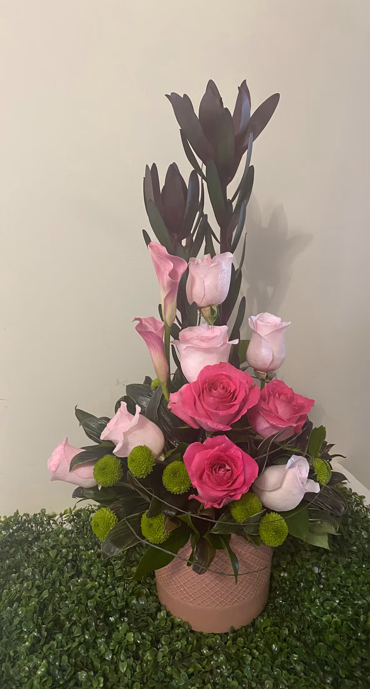 Sweet Success arrangement with pink roses, calla lilies, leucadendron, and greenery