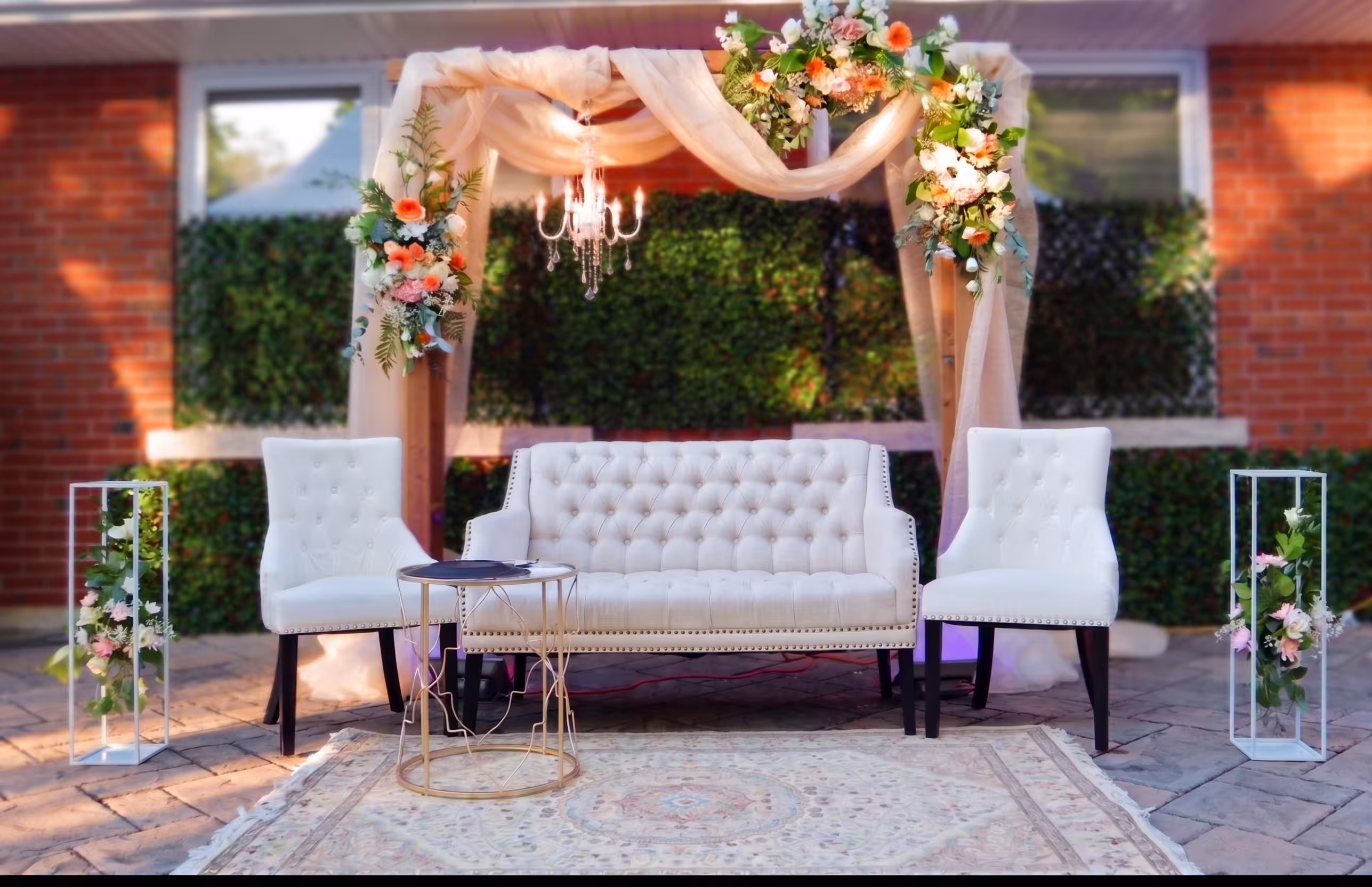 Pastel floral and draped fabric stage canopy over a lounge seating area