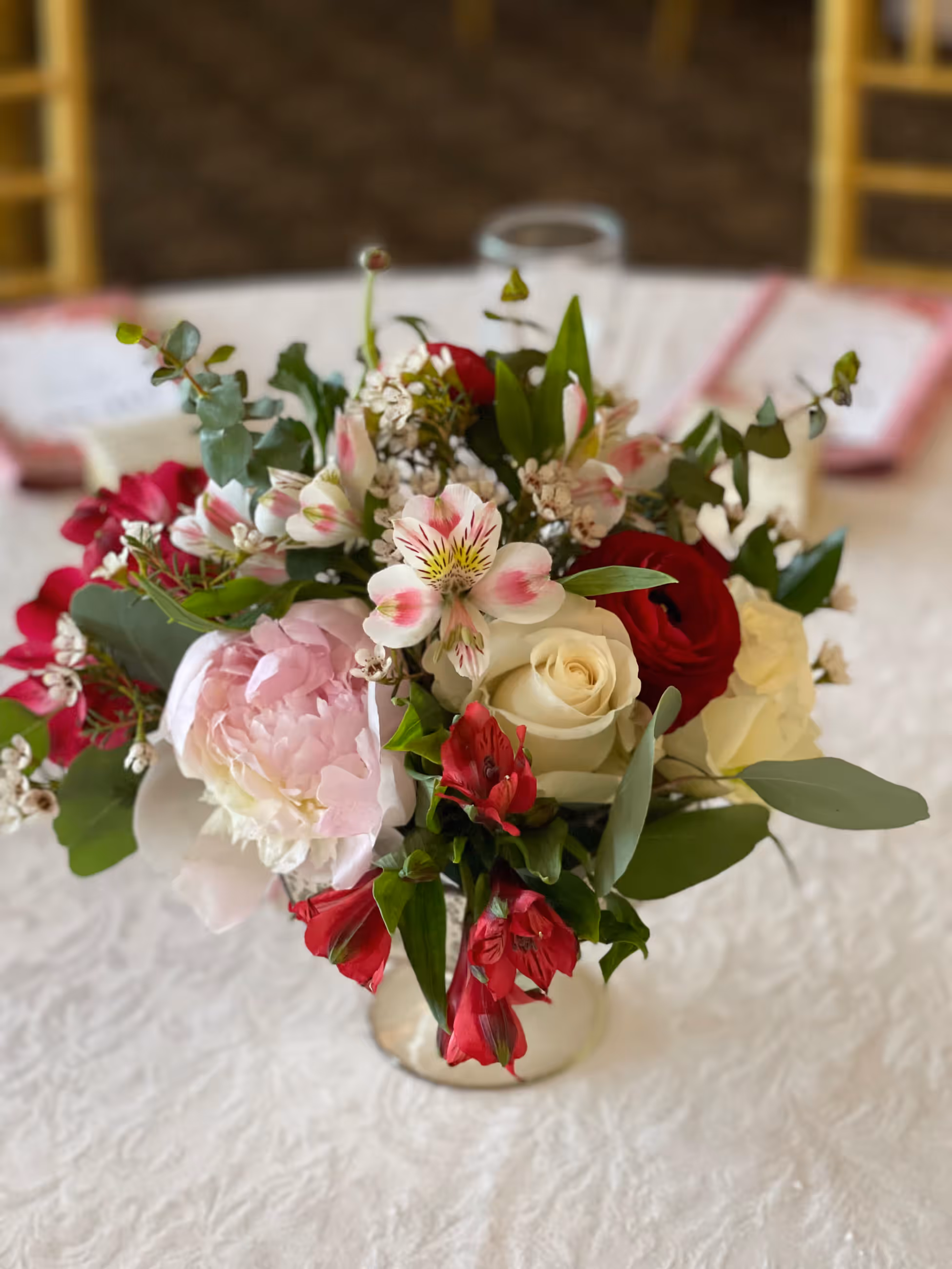 Closeup of a pink, red and cream floral centerpiece